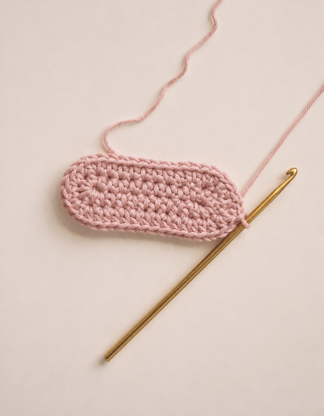 Completed oval sole shape after Row 2 increases for crochet baby shoes